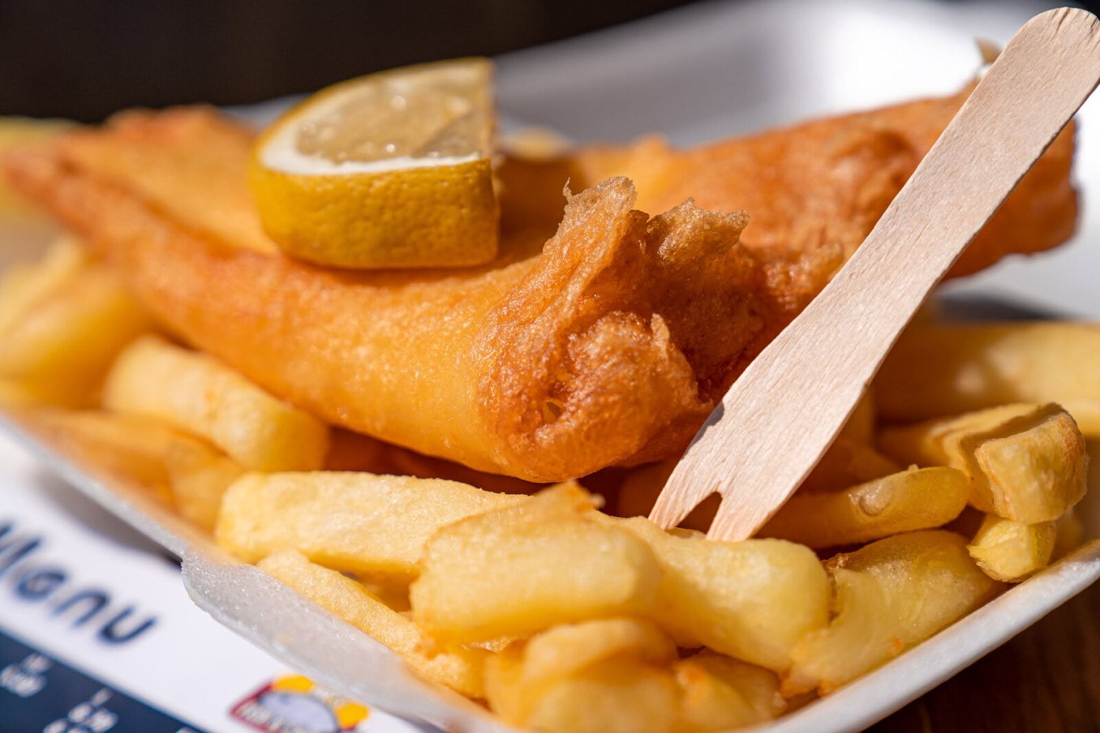 Crisp battered fish with lemon and chunky chips